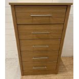 A contemporary five drawer tall boy with stainless steel bar handles (H115cm W66cm D45cm)