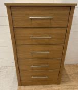 A contemporary five drawer tall boy with stainless steel bar handles (H115cm W66cm D45cm)