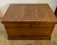 A large pine panelled blanket box or chest with brass drop handles to sides (H70cm W109cm D73cm)