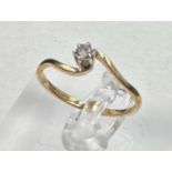 A 9ct and diamond wishbone style ring, approximate size P 1/2and weight 1.5g.