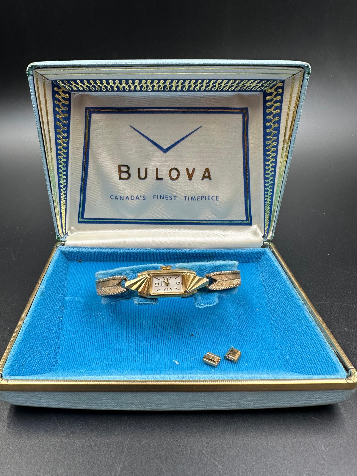A 14k yellow gold Bulova ladies wristwatch on gold plated bracelet with original box etc