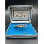 A 14k yellow gold Bulova ladies wristwatch on gold plated bracelet with original box etc