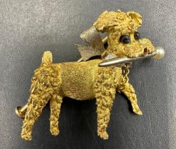 An 18ct gold brooch of a small terrier with pearl capped stick in its mouth (Total weight 5.8g)