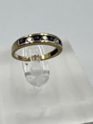 A 9ct gold diamond and sapphire ring, approximate size I.