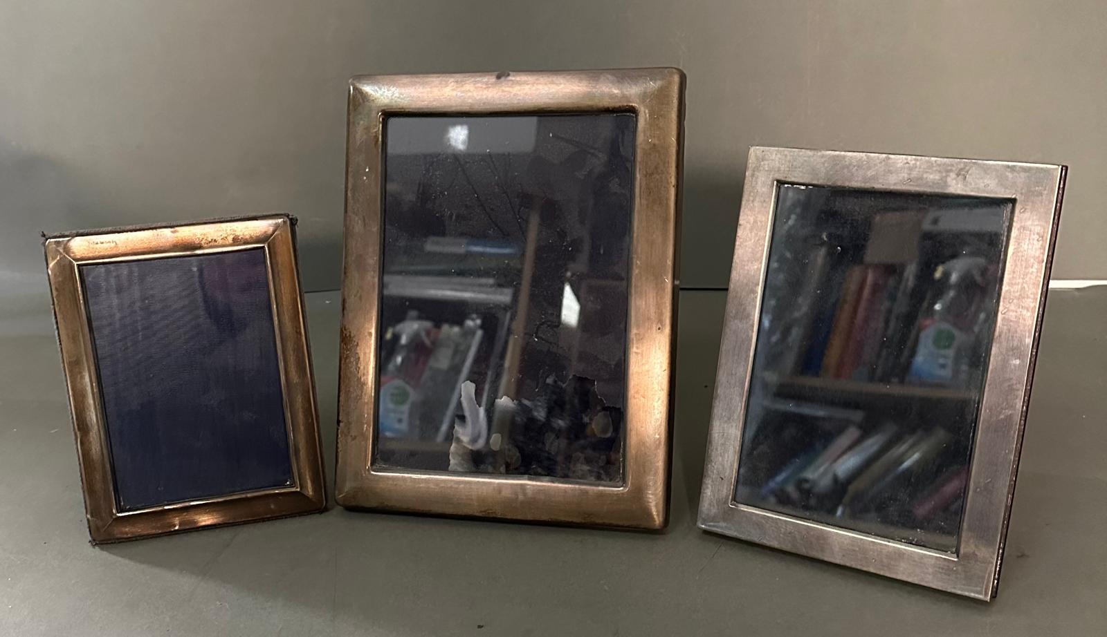 Three silver photograph frames marked 925 (Largest 17cm x 22cm)