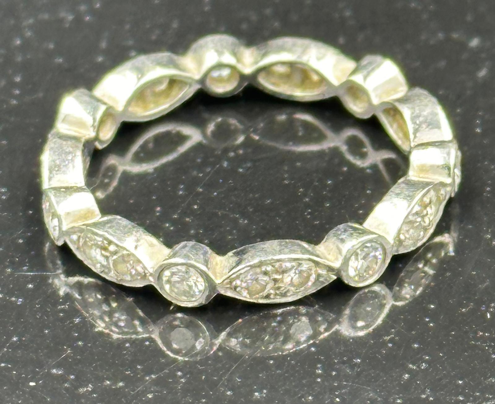 Diamond eternity ring mounted in platinum. Signed T&C 950. Total diamond weight approximately