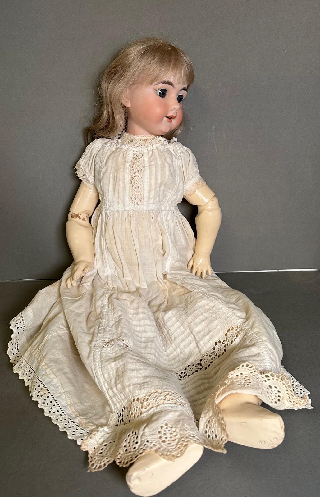 An antique German doll with carved wooden body