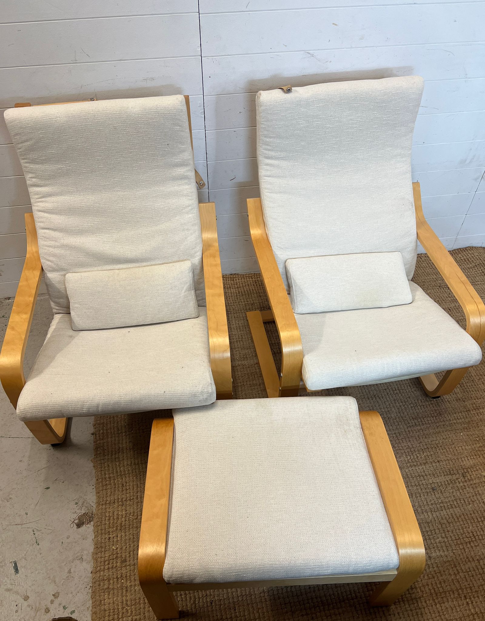 A pair of Ikea Poang chairs and matching footstool