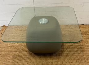 A glass side table with faux stone style base (H36cm Sw70cm)
