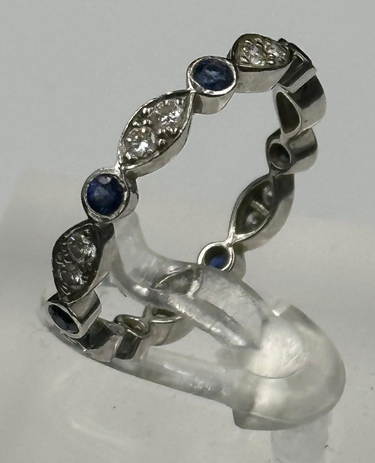 Sapphire and round diamond eternity ring mounted in platinum. Signed T&C 950. Total diamond weight