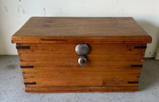 A Middle Eastern style storage trunk with brass handles, metal brackets to corners and diamond inlay