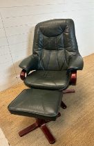 A green leather upholstered reclining arm chair and matching foot stool