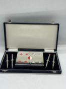 A cased bridge set with pens and cards