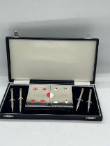 A cased bridge set with pens and cards