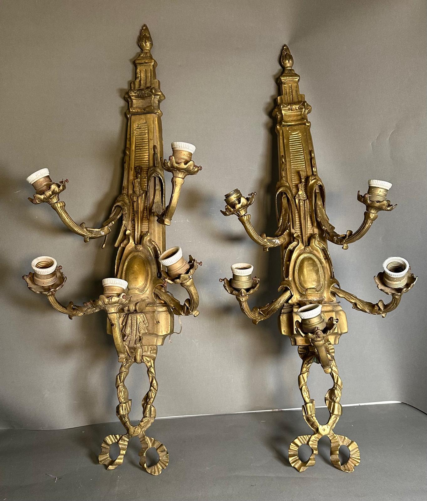 A pair of brass Louis XVI style five arm wall sconces