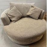 A circular beige armchair on a swivel base