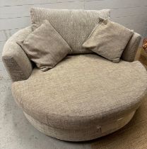A circular beige armchair on a swivel base