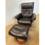 A black leather ergonomic stressless arm chair and matching foot stool