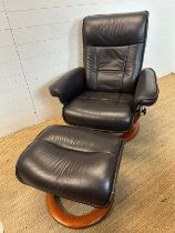 A black leather ergonomic stressless arm chair and matching foot stool