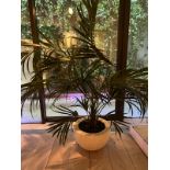 A artificial palm plant in white pot