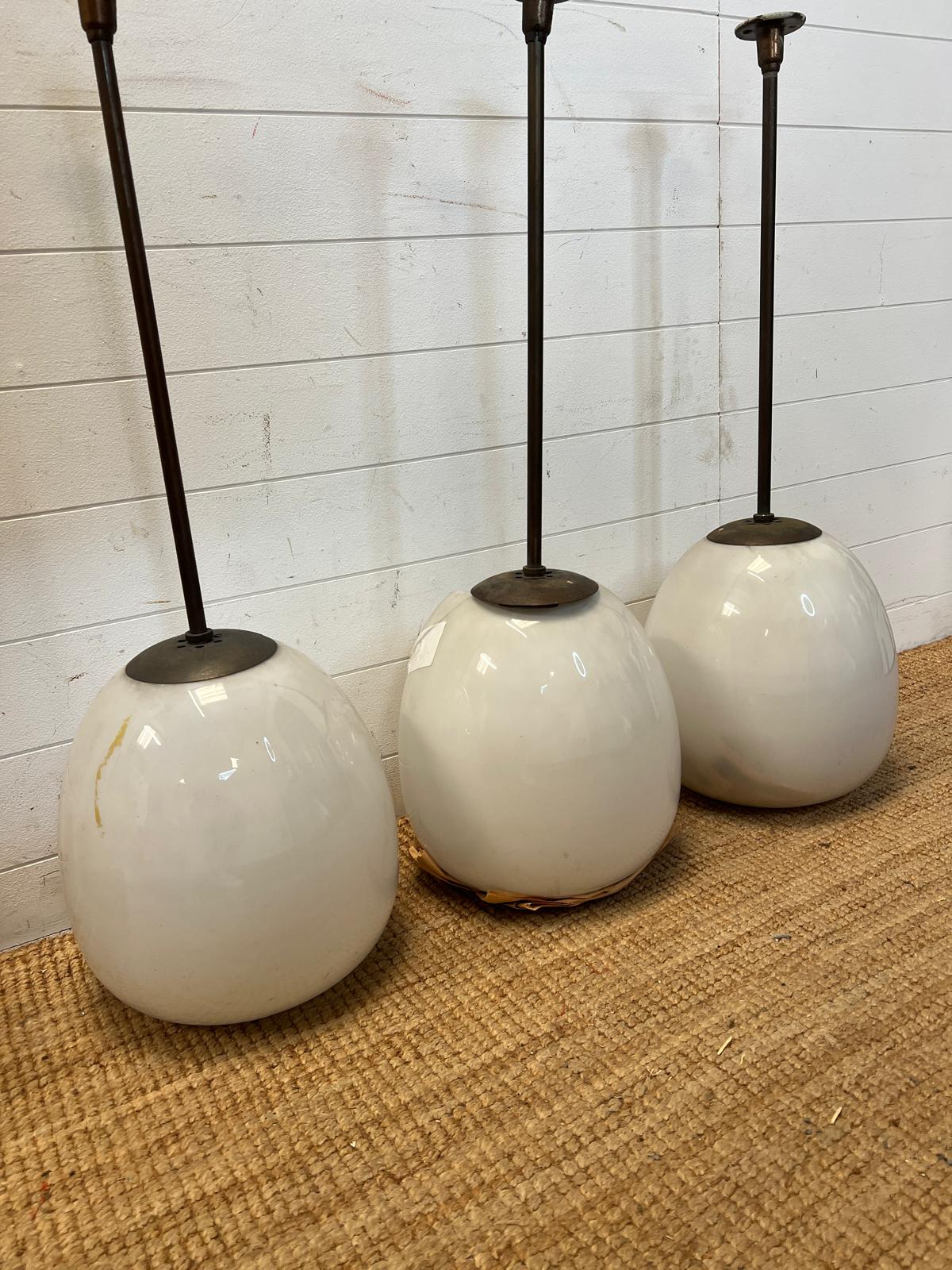 Three industrial 1930's pendant ceiling lights with opaline glass tulip shades by General Electric