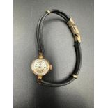 A rare ladies Omega gold watch on leather bracelet with image of a Sheik's head.