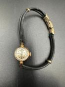 A rare ladies Omega gold watch on leather bracelet with image of a Sheik's head.