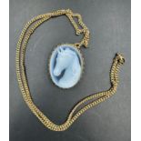 A 9ct gold chain with 9ct gold pendant, cameo style of a horses head. (Approximate weight of
