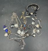 A selection of silver jewellery including a Links of London friendship bracelet with black thread.