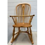 A pine high back Windsor rocking chair