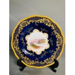 A selection of five early 20th century Coalport hand painted plates with blue grounds, under an acid