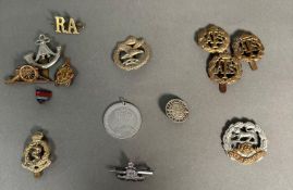 A selection of military capo badges and insignia various regiments to include Royal Artillery,