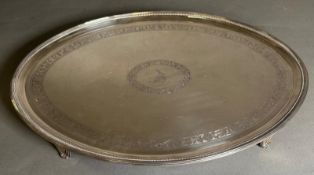 A William IV silver tray on four feet, approximately 43.5cm in length and an approximate total