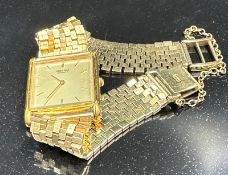 A Seiko watch on an 18ct gold bracelet with additional safety chain with an approximate weight of