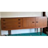 A Mid Century teak sideboard, three drawers and a two door cupboard (H74cm W174cm D44cm)