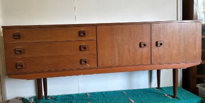 A Mid Century teak sideboard, three drawers and a two door cupboard (H74cm W174cm D44cm)