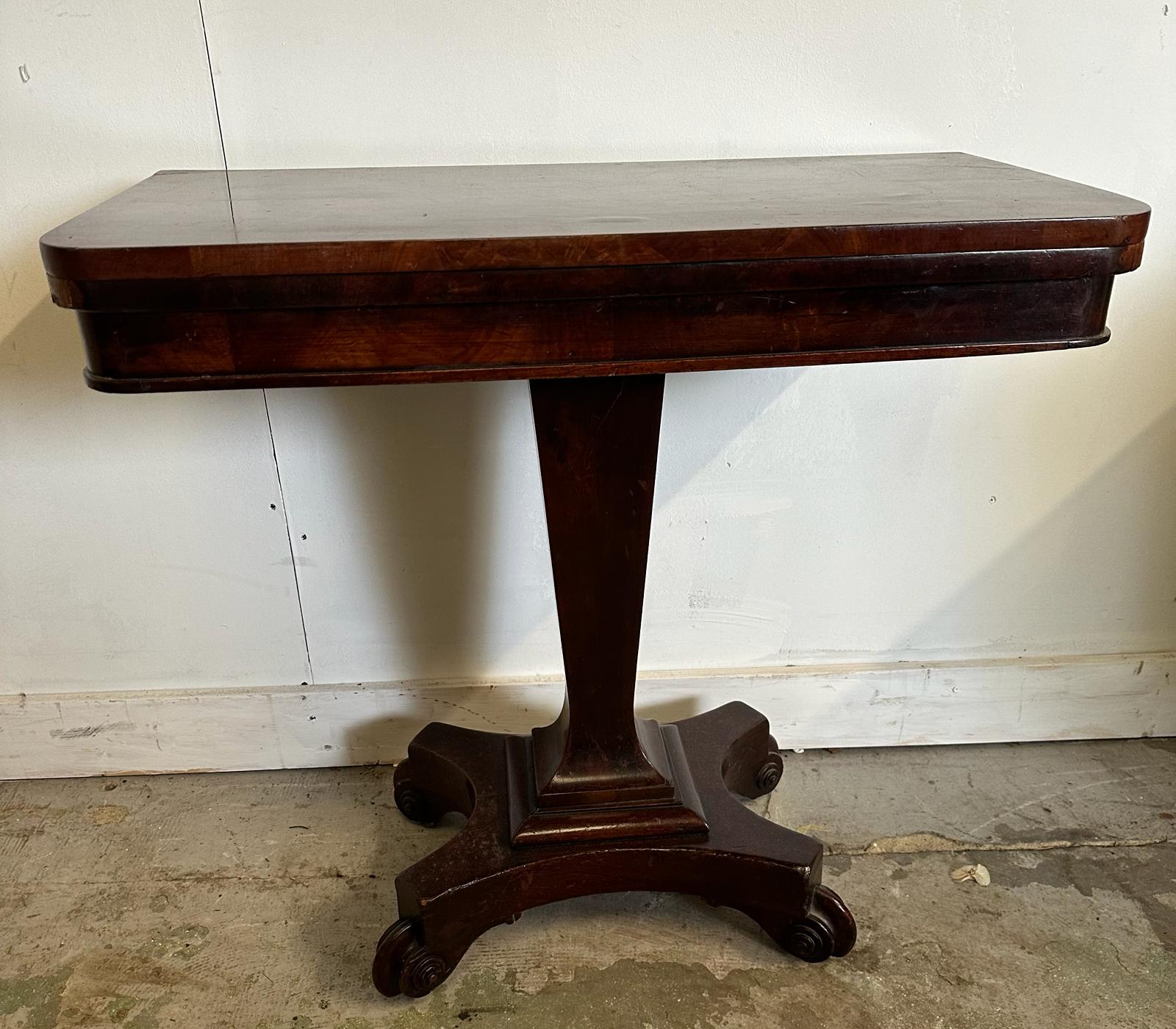 A mahogany folding card table with a green baize top on castors (H58cm W76cm D38cm)