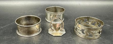 Three silver napkin rings and a silver place card holder various hallmarked (Total weight 80g)