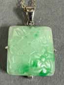 A square jade pendant on a 9ct gold necklace.