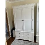 A white two door wardrobe with four drawers below and hanging space above (H200cm W114cm D55cm)