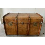 A vintage wooden banded steamer trunk with brass fittings and leather strap handles to ends
