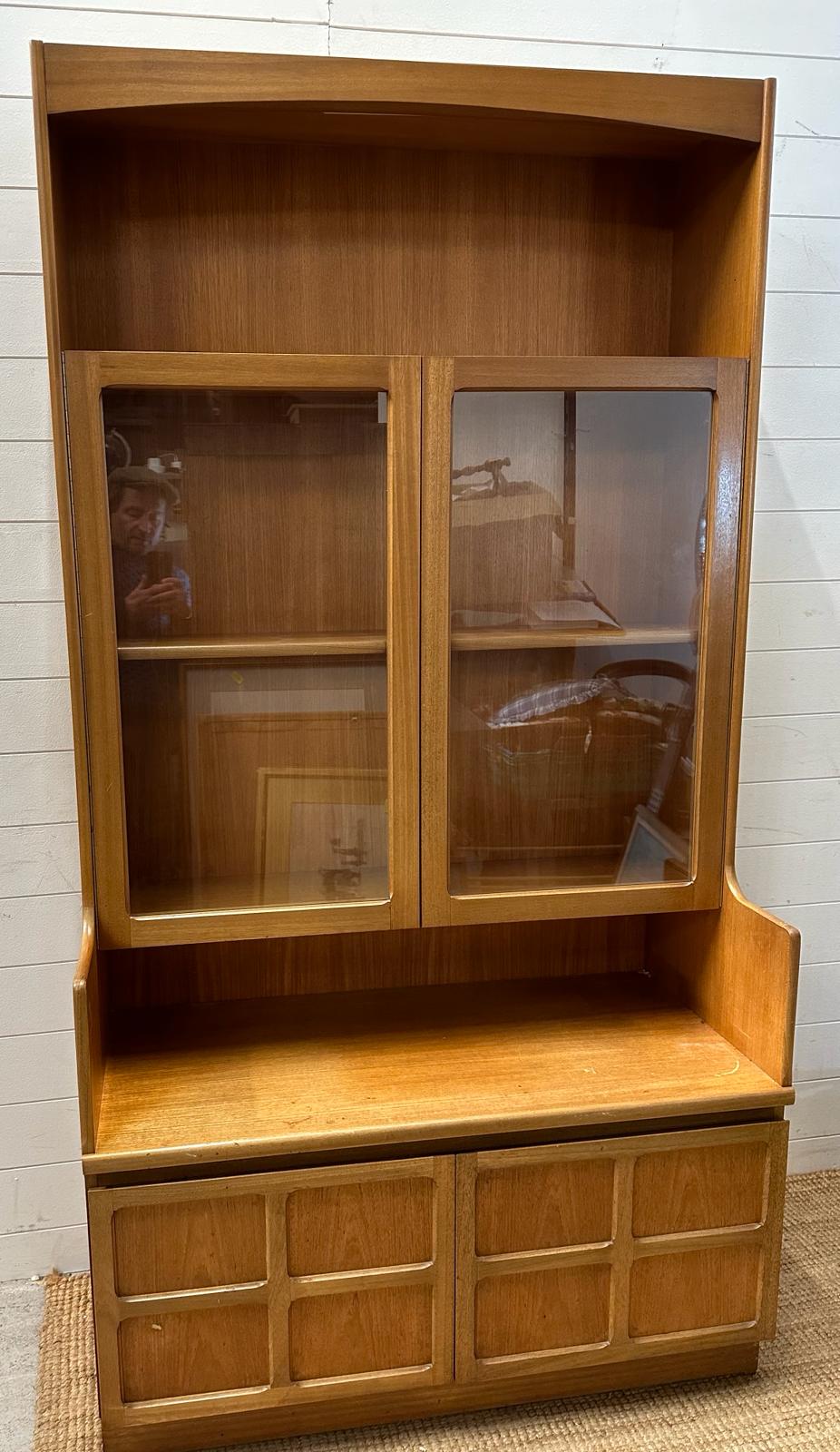 A Mid Century wall cabinet by Nathan, comprising of two door glazed cupboards, two door cupboard