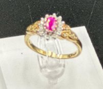 A 9ct gold ruby and diamond ornate ring in yellow gold setting, approximate size O1/2