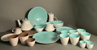 A part pool pottery breakfast set in browns and green and white to include cups, saucers, egg cups