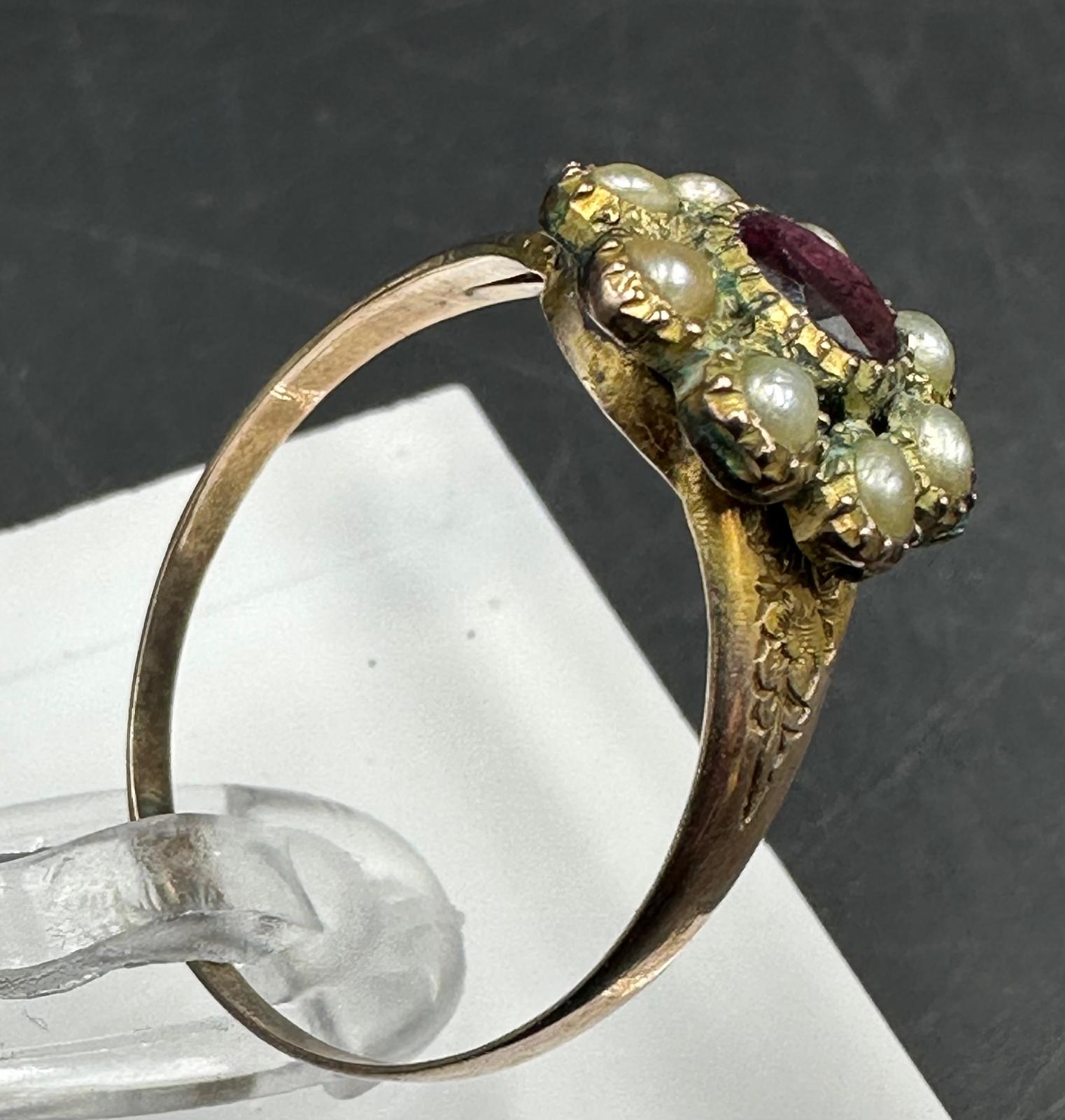 A 9ct gold daisy style ring with central ruby and seed pearls, approximate size Q and weight 2.2g
