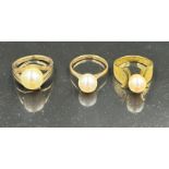 Three 14ct gold pearl rings in various styles, with an approximate weight of 10.6g.
