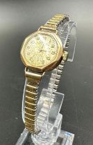 A 9ct gold watch on a stainless steel bracelet