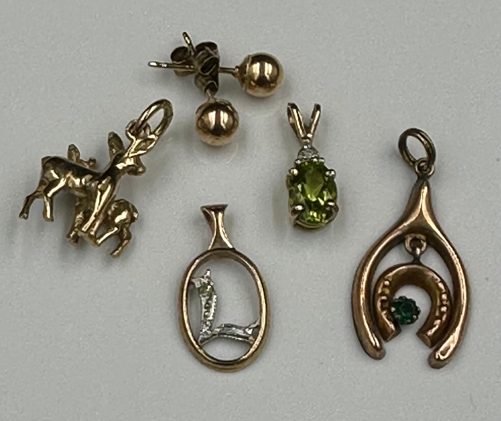 A selection of five 9ct gold items to include, charm, pendants earrings with a combined total weight