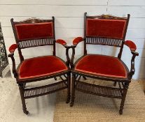 A pair of salon chairs with satinwood inlay on castors.