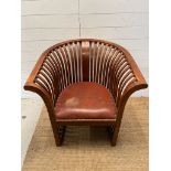 A teak slatted curved round armchair in the style of Hoffman